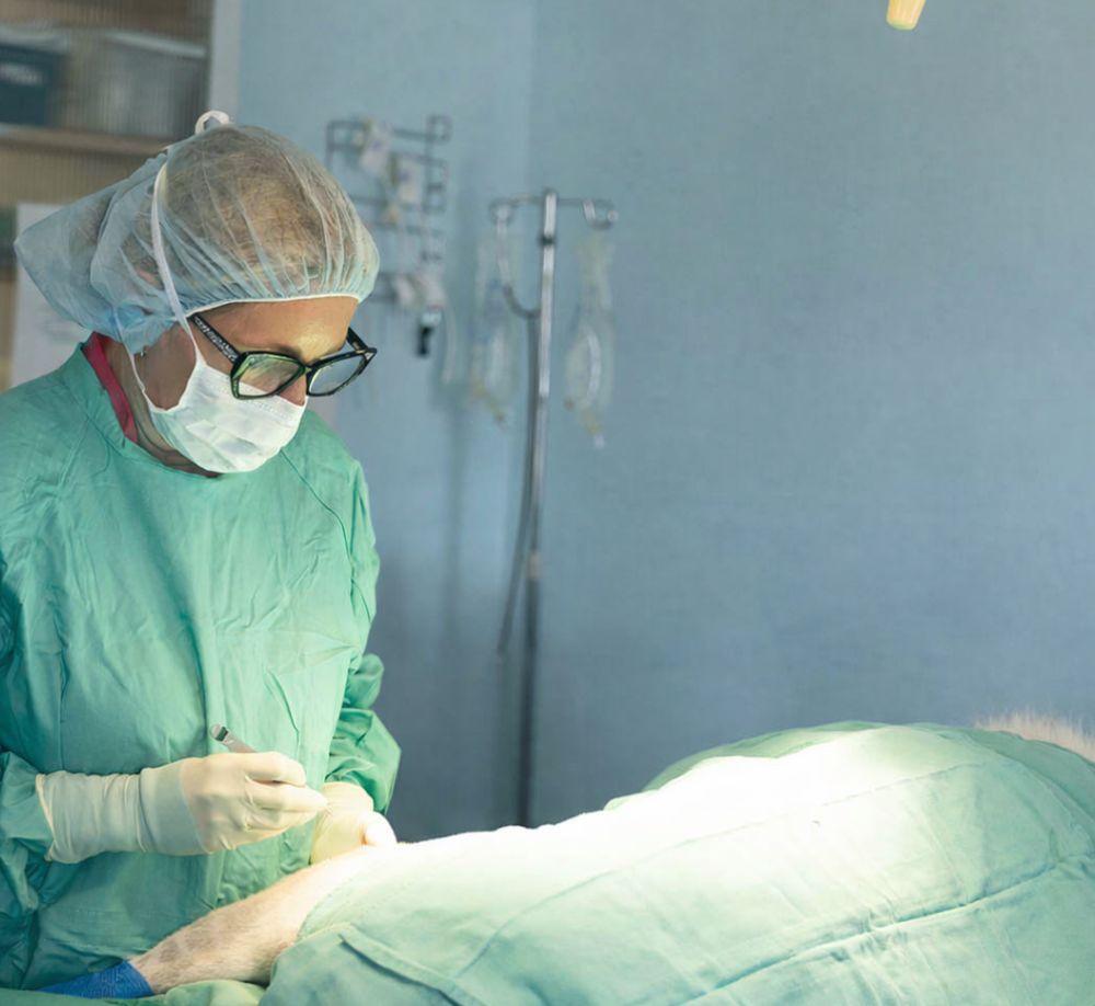 Surgeon operating on patient Surgeon operating on patient